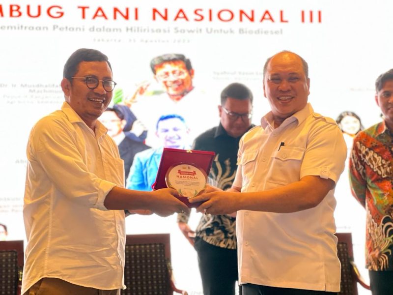 Bupati Konawe Utara, H. Ruksamin (Kanan), menerima cinderamata dari Rembuk Tani Nasional Petani Kelapa Sawit Indonesia 2023.