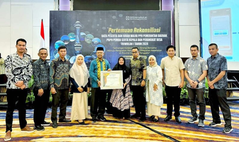 Kepala BPJS Cabang Kendari, Rinaldi Wibisono penyerahkan sertifikat Penghargaan kepada Bupati Konawe Utara yang diwakili oleh Asisten III Administrasi Umum, La Ondjo, di Hotel Claro Kendari pada Kamis, 16 Mei 2024.