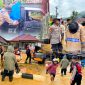 Jajaran personel polres konawe utara bantu evakuasi warga terdampak banjir meluapnya kali anggomate di andowia. Selasa (30/07/2024).